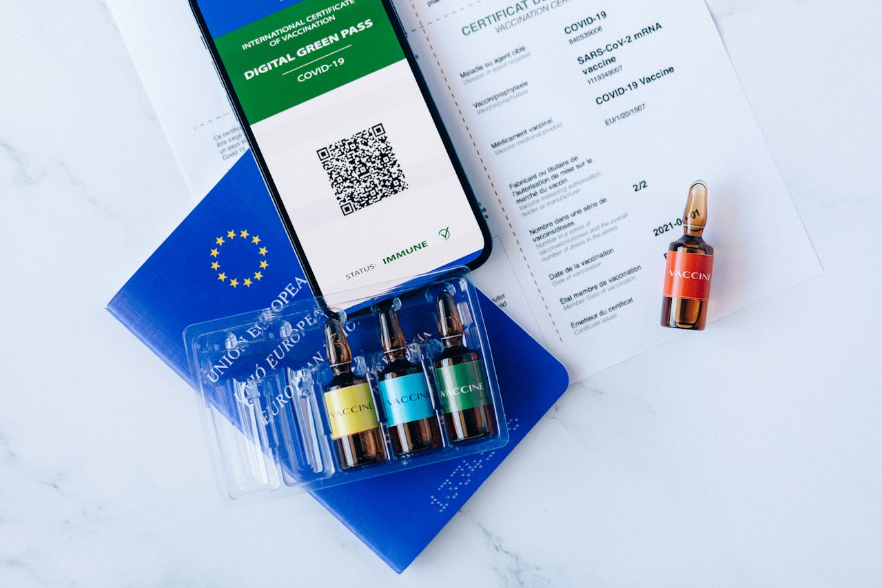 Crafting Captivating Headlines: Your awesome post title goes here Digital green pass and vaccination vials on European Union passport, symbolizing COVID-19 travel readiness.